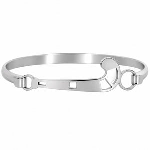 A polished silver-tone metal bangle bracelet with a unique field hockey openwork design and circular connector rings, shown on a plain white background.