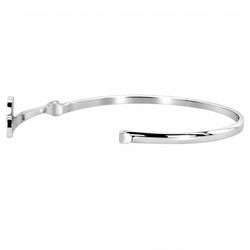 A polished silver-tone metal cuff bracelet with a minimalist, open design and a small decorative tab on one end, shown against a plain white background.