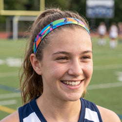 Woman wearing a colorful headband on a sports field