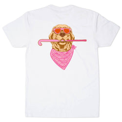 A white short-sleeve t-shirt with a graphic print of a golden retriever dog wearing pink sunglasses and a pink bandana, holding a pink field hockey stick.