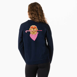A woman viewed from the back wearing a navy blue sweatshirt with a large graphic of a dog wearing sunglasses and a pink bandana on the back, paired with black leggings against a white background.