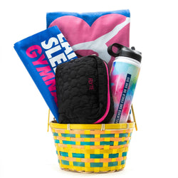 Basket with gym accessories including a towel, water bottle, and pouch on a white background