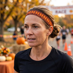 Woman wearing a black shirt and orange turkey headband with a race backdrop