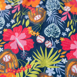 Fabric with baseball-themed design featuring flowers, leaves, and baseballs on a dark blue background.