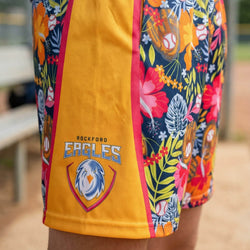 Colorful shorts with floral patterns and 'Rockford Eagles' logo on a blurred outdoor background