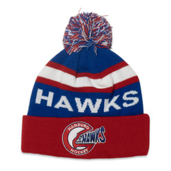 A red, white, and blue knit pom-pom beanie with 'HAWKS' in white across a blue section and a red cuff featuring a Hamburg Hawks Hockey logo.
