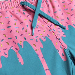 Close-up of pink and blue shorts with colorful sprinkles pattern