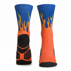 A pair of crew-length athletic socks shown from the back, featuring a blue upper section with yellow and orange flame graphics, an orange lower section, and a black heel and toe area, set against a plain white background.
