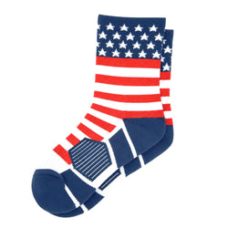 A pair of crew socks featuring an American flag design with red and white stripes, white stars on a navy blue background, and navy blue sections on the toe and heel, shown on a light gray background.