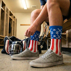 Person wearing hockey American flag socks in a locker room setting