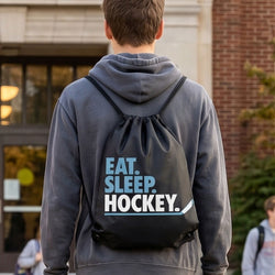 Teen wearing a Eat Sleep Hockey drawstring backpack in a school.