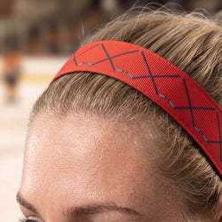 Close-up of a person wearing a red headband with hockey pattern.