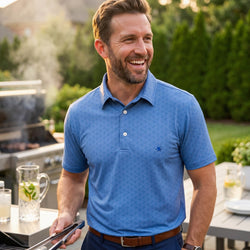 Man wearing a blue hockey patterned polo shirt outdoors at a bbq.