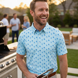 Man wearing a hockey patterned polo shirt outdoors at a bbq.