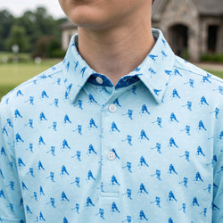 Light blue polo shirt with hockey player pattern worn by a person outdoors.