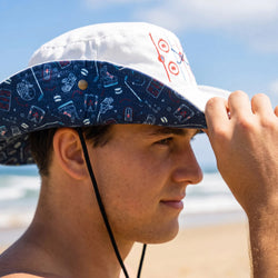 Person wearing a colorful hockey bucket hat on a beach