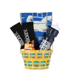 Basket with hockey-themed items including a water bottle, socks, and a tee on a white background