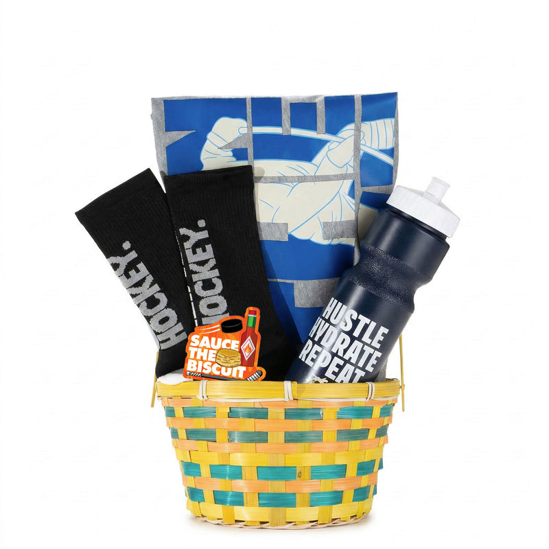 Basket with hockey-themed items including a water bottle, socks, and a tee on a white background