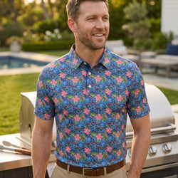Person wearing a tropical themed polo shirt with hockey pattern  outdoors at a cookout.