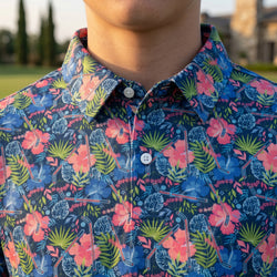 Person wearing a tropical themed polo shirt wit hockey pattern design.
