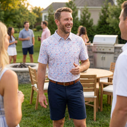 Person wearing a patriotic hockey themed polo shirt outdoors at a cookout.
