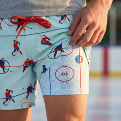 Person wearing ice hockey-themed shorts with a blurred background