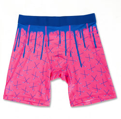 Flat lay of pink and blue hockey shorts with a crossed stick design and dripping effect