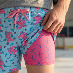 Person wearing colorful shorts with hockey-themed design.
