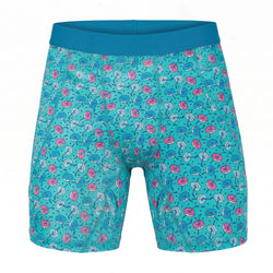 Teal shorts with a colorful hockey donut pattern on a white background