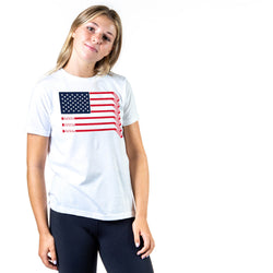 Person wearing a white t-shirt with an American flag hockey stick design on a white background