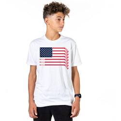 Person wearing a white t-shirt with an American flag hockey stick design on a white background