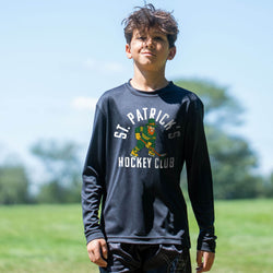 Child wearing a 'St. Patrick's Hockey Club' long sleeve tee outdoors.