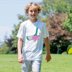 Child wearing a white t-shirt with a colorful hockey donut graphic design outdoors on a sunny day.
