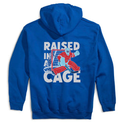 Royal blue hoodie with a graphic of a hockey goalie and text 'Raised in a Cage' on the back.