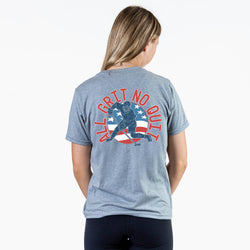 Girl wearing a gray t-shirt with 'All Grit No Quit' and American flag design on the back.