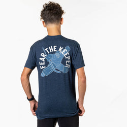 Person wearing a blue t-shirt with 'Fear The Keeper' graphic on the back