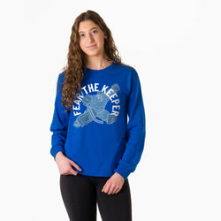 Person wearing a blue long sleeve tee with 'Fear the Keeper' graphic design on a white background