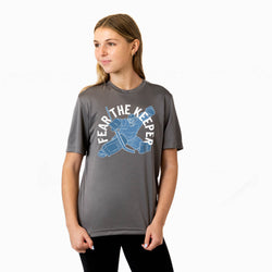 Person wearing a gray t-shirt with 'Fear The Keeper' graphic design on a white background