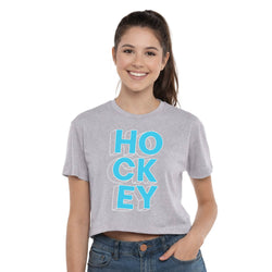 Woman wearing a gray t-shirt with 'Hockey' printed in blue on a white background