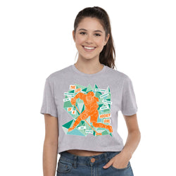 Woman wearing a gray t-shirt with a colorful graphic design of a hockey player.