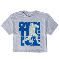 Gray t-shirt with blue graphic of a hockey player and 'OWN THE ICE' text on a white background