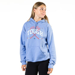 Woman wearing a blue hoodie with 'Pretty Tough' text on a white background