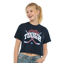 Girl wearing a navy t-shirt with 'pretty tough' text and hockey stick graphics on a white background