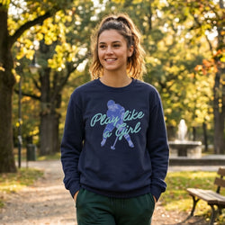 Woman wearing a navy blue sweatshirt with a hockey girl graphic and text in an outdoor setting
