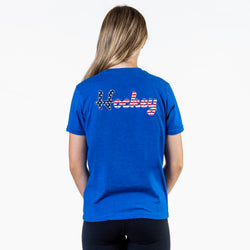 Person wearing a blue t-shirt with 'Hockey' printed on the back against a white background