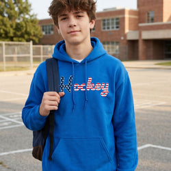Person wearing a blue hoodie with 'Hockey' text in a schoolyard setting