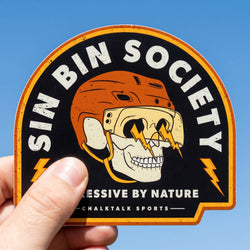 Sticker with 'Sin Bin Society' design held against a blue sky