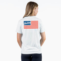 Person wearing a white t-shirt with an American flag design and hockey text on the back
