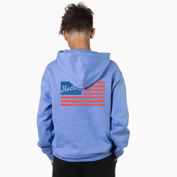 Person wearing a blue hoodie with a usa flag design on the back against a white background