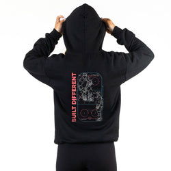 Black hoodie with a hockey design on the back and 'Built Different' text, worn by a person against a white background